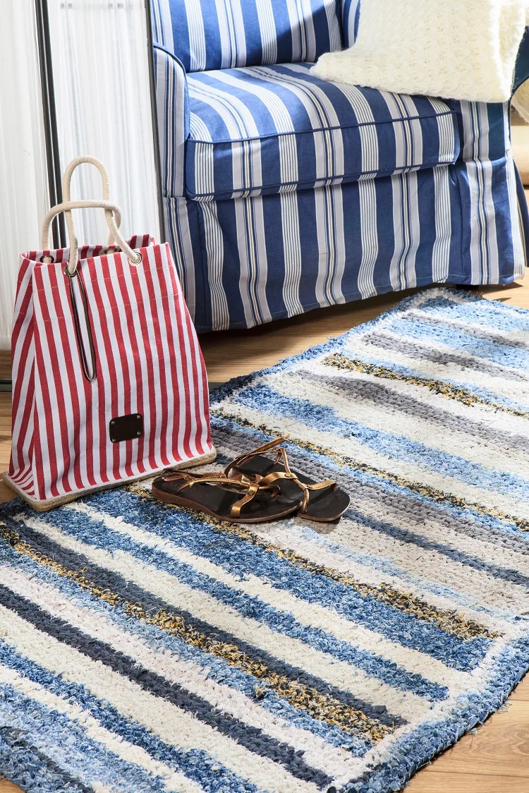 a blue and white striped knitted rug
