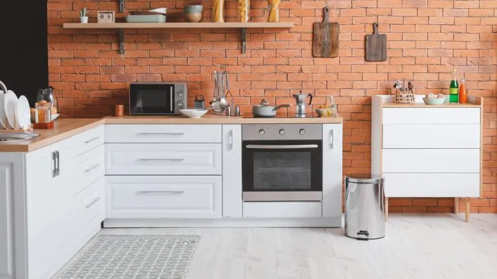 Kitchen area rug over white hardwood floors