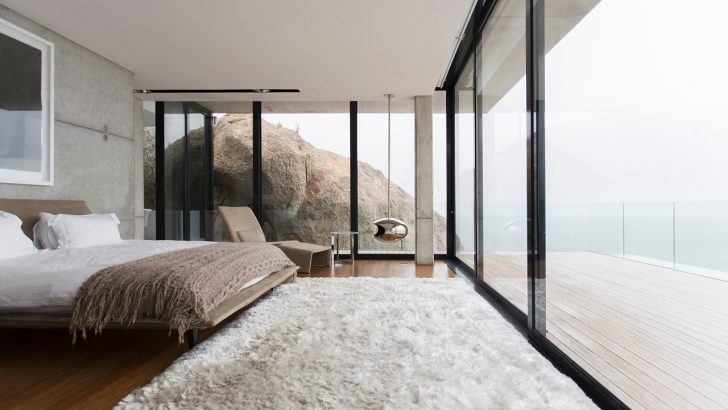 Shag rug and glass walls in modern bedroom