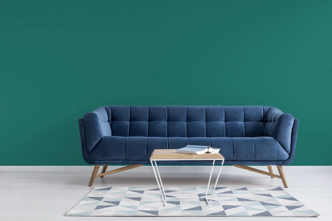 teal walls with blue couch