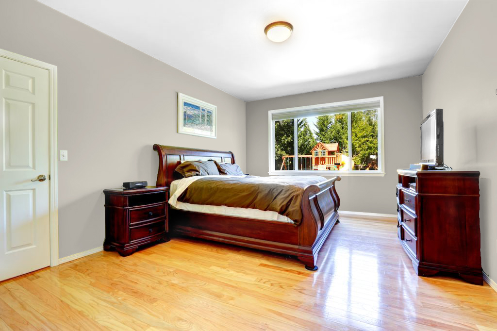 beige walls with cherry wood bedroom furniture